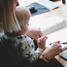 a teacher drawing with an infant